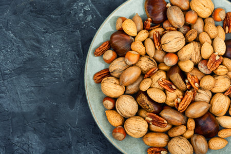 Walnut, chestnut, almond and hazelnut on table. Vegetarian snacks.