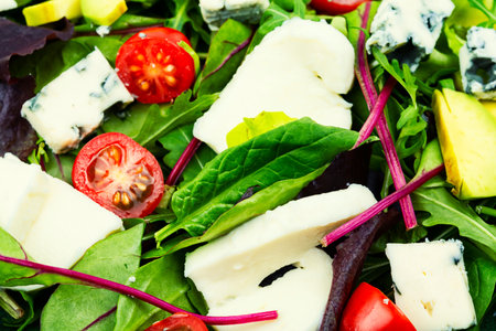 Salad with lettuce, greens, avocado, tomatoes and mix cheeses. Healthy foodの写真素材