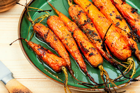 Fried carrots with herbs and spices on the plateの写真素材