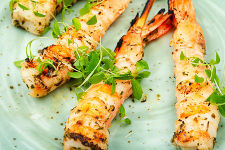 Tiger shrimp barbecue with herbs grilled on wooden sticks.の写真素材