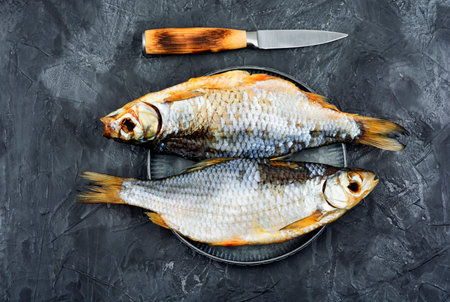 Whole dried salted fish on the table. Stockfish. Top view.