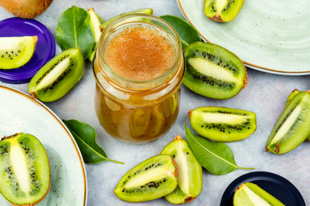 Sweet kiwi jam jar with raw fruit ,jam kiwi in a glass jarの写真素材