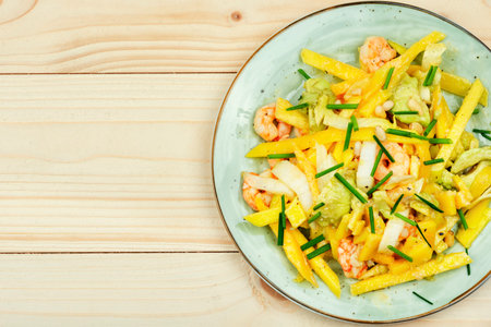 Salad with grilled prawns, mango, avocado and pine nuts.Copy space, recipe placeの写真素材