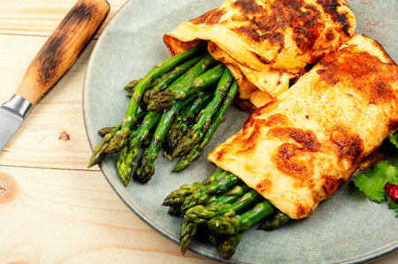 Appetizing homemade omelette cooked with green asparagus.の写真素材