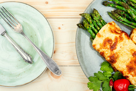 Egg omelet cooked with green asparagus on rustic wooden tableの写真素材