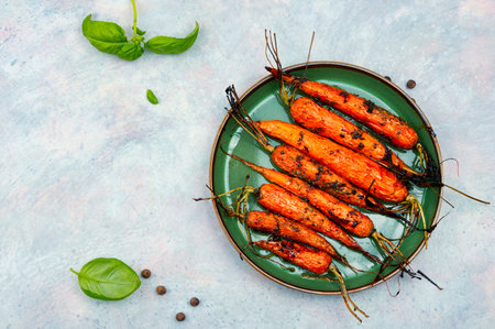 Baked with herbs and spices carrots. Space for textの写真素材