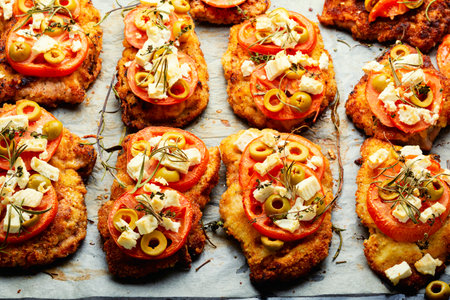 Chicken chops with tomato, olives and cheese. Chicken meat