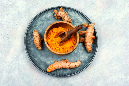 Turmeric root and turmeric powder. Fresh homeopathic herbs. Turmeric spice. Flat lay.