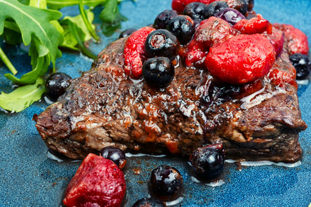Delicious grilled meat medallions with berries sauce. Close up.の写真素材