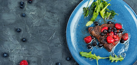 Beef steak cooked with blueberry and raspberry sauce. Barbecue. Space for textの写真素材
