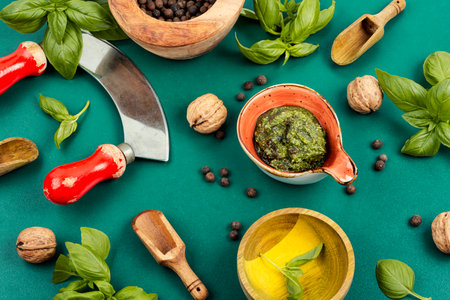 Preparation of traditional Italian pesto sauce from fresh green basil.の写真素材