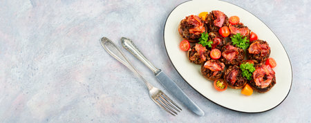 Plate with mushrooms stuffed with minced meat and bacon. Copy space.の写真素材