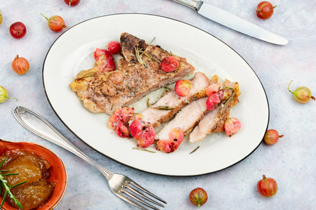 Delicious grilled beef steak with gooseberry. Fried tenderloin fillet steak.の写真素材