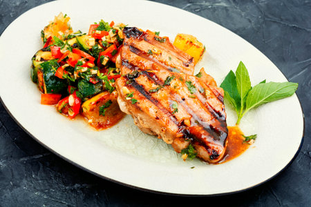 Cooked tuna steak with vegetables on a plate. Seafood.の写真素材