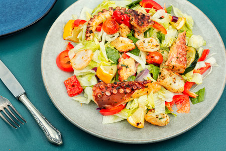 Healthy salad of fresh vegetables and grilled octopus in plate.の写真素材
