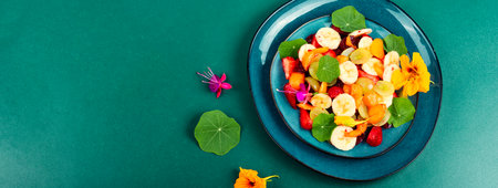 Diet salad with banana, strawberries, grapes and nasturtium. Low calorie desserts. Copy space.の写真素材