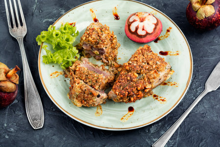 Plate of steak of baked tuna in a nut panic with a mangosteens.の写真素材