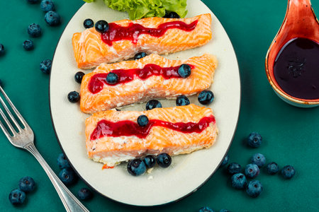 Baked salmon fish with blueberry berry sauce. Salmon fillets, grilled steaks.