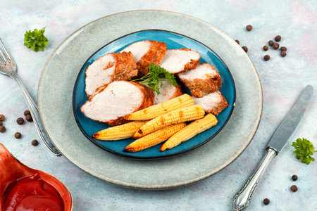 Roasted pork tenderloin with grilled corn. Baked meatの写真素材