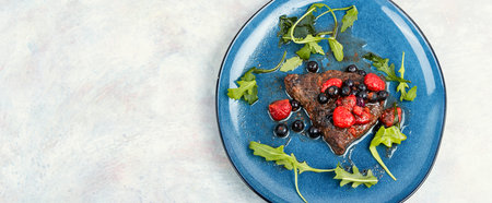 Beef steak cooked with blueberry and raspberry sauce. Barbecue. Space for text