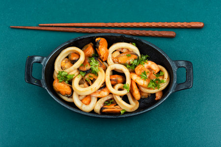 Roasted mussels, squid and shrimp. Seafood assorted and chopsticksの写真素材