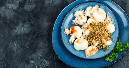 Baked young squids with nut garnish. Copy space. Korea traditional food.の写真素材