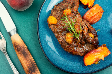 Diet beef steak roasted with peach on a plate.の写真素材