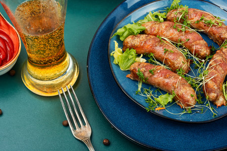 Roasted pork meat sausages on plate. Beer and bavarian sausages, Oktoberfest celebration.の写真素材