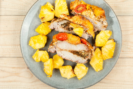 Meat roasted with fresh pineapple on wooden rustic backgroundの写真素材