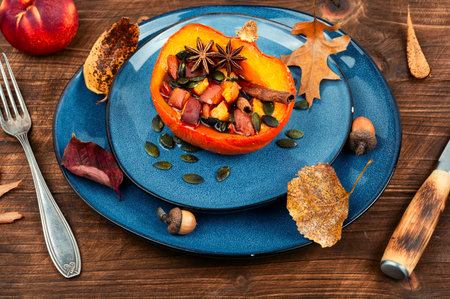 Half of the pumpkin baked with apples, peaches and cinnamon. Fall lunch, baked squash. Healthy vegetarian foodの写真素材