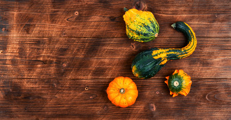 Autumn background with pumpkins on old wooden table, copy space. Autumn harvest concept.の写真素材
