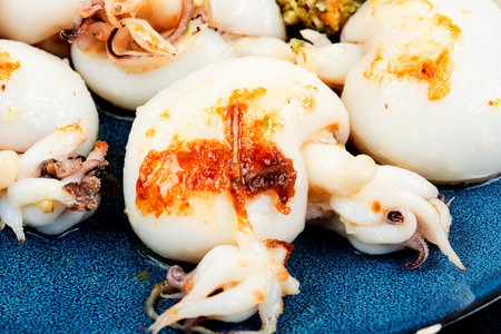 Fried squid or calamari served with nut salad. Roasted whole calamari.の写真素材