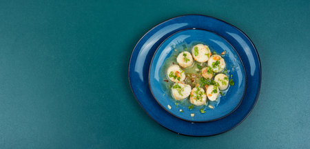 Roasted scallops with green on a plate, seafood. Delicatessen sea scallop. Copy space.の写真素材