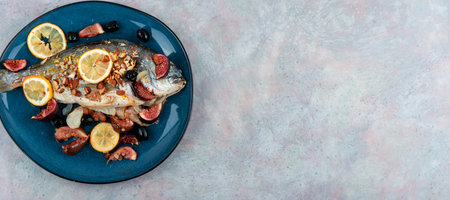 Baked dorado fish with almonds and figs. Autumn recipe. Space for textの写真素材