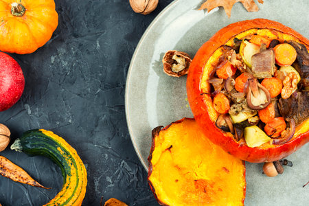 Autumn dish, baked pumpkin stuffed with beef meat, mushrooms, apple and vegetables. Top view.の写真素材