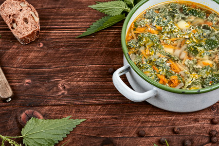 Nettle soup in a saucepan. Stinging nettle soup. Healthy food, copy space.の写真素材