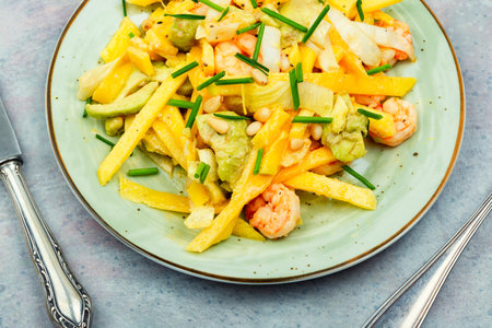 Fresh salad with roasted prawns, mango, ripe avocado and pine nuts. Healthy eatingの写真素材