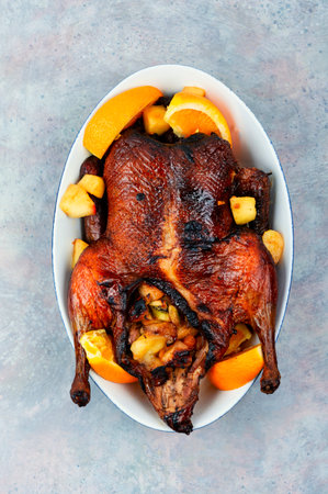 Whole duck baked with oranges and caramelized apples.の写真素材