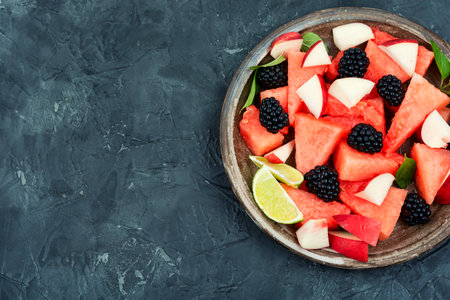 Vitamin salad of watermelon, blackberry and peach. Summer fruit diet salad. Top view with copy space.の写真素材