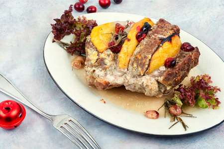 Delicious pork roll roasted with aromatic mango pieces. Christmas food. American dinner.の写真素材