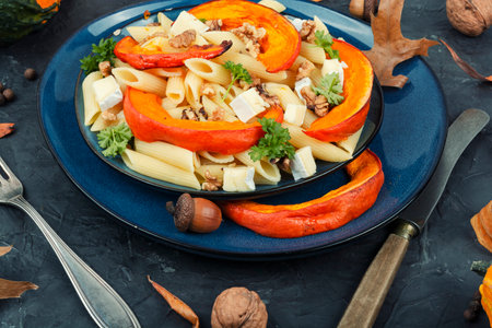Pasta with baked pumpkin or squash, cheese and walnuts. Seasonal autumn food.の写真素材