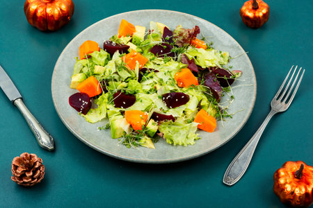 Autumn vegetarian salad of roasted pumpkin, beets and lettuce. Healthy homemade food.の写真素材