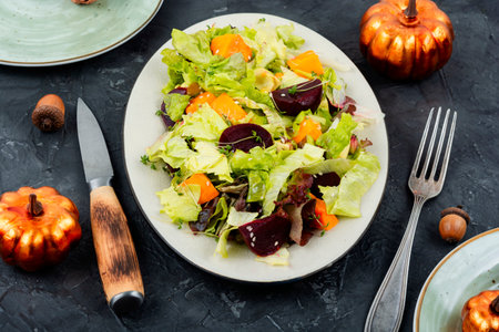 Seasonal autumn salad of roasted pumpkin, beets and lettuce. Autumn food concept.の写真素材