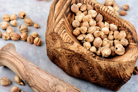 White dried cardamom in a wooden mortar, spice.の写真素材