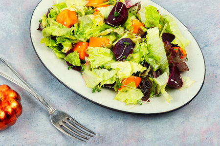 Seasonal autumn vegetable salad of roasted pumpkin, beets and greens. Green vegan salad.の写真素材