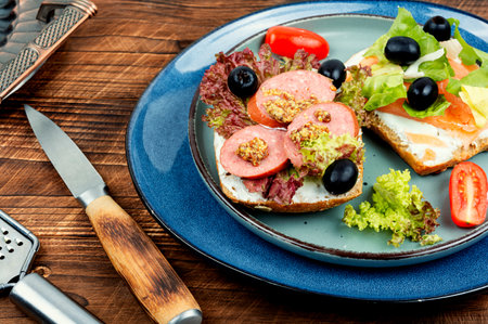 Open sandwiches with salted salmon and sausages for breakfastの写真素材