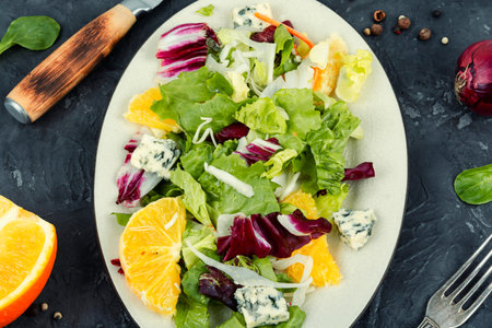 Fresh salad with greens, orange and cheese.の写真素材