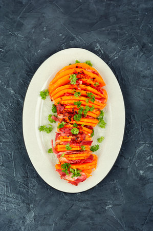 Plate with roasted pumpkin with bacon. Baked butternut squash. Pumpkin recipes.の写真素材