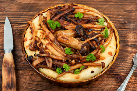Rustic homemade mushroom pie or mushroom galette on a wooden table. Breakfast dish.の写真素材