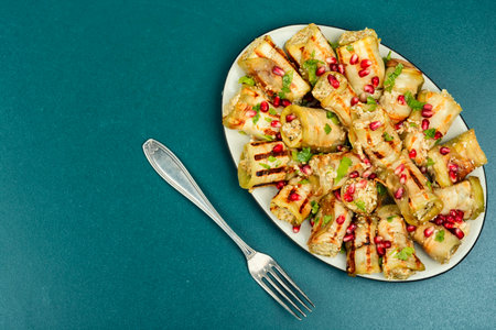 Badrijani, baked eggplant stuffed with walnut paste. Dish of Georgian cuisine. Copy space.の写真素材